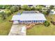 A bird's eye view of home with great curb appeal, lush landscaping and a long driveway at 2236 Arnet St, Port Charlotte, FL 33948