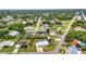 Expansive aerial view of a home nestled in a lush community with tree-lined streets and mature landscaping at 2236 Arnet St, Port Charlotte, FL 33948