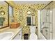 Bathroom featuring patterned wallpaper, a glass-enclosed shower, and modern fixtures at 2236 Arnet St, Port Charlotte, FL 33948