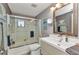 Cozy bathroom features a shower-tub combination, single sink vanity, framed mirror, and decor at 2236 Arnet St, Port Charlotte, FL 33948