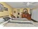 Comfortable bedroom with a ceiling fan, complemented by a round mirror above a wooden dresser at 2236 Arnet St, Port Charlotte, FL 33948