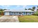 Charming single-story home showcasing a well-manicured lawn, painted exterior, and a neatly paved driveway at 2236 Arnet St, Port Charlotte, FL 33948
