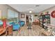Comfortable living room with stylish decor, including wood-look floors, and art, creating a welcoming ambiance at 2236 Arnet St, Port Charlotte, FL 33948