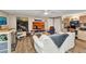 Bright living room with a ceiling fan, white sofa, art, and wood-look flooring, perfect for relaxing and entertaining at 2236 Arnet St, Port Charlotte, FL 33948