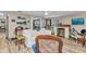 Cozy living room featuring wood-look flooring, a white sofa, art, and natural light, perfect for relaxation and gatherings at 2236 Arnet St, Port Charlotte, FL 33948