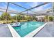 Clear blue pool surrounded by tropical greenery under a screened enclosure at 2236 Arnet St, Port Charlotte, FL 33948