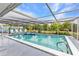 Inviting pool area with clear blue water, lounge chairs, and tropical landscaping at 2236 Arnet St, Port Charlotte, FL 33948