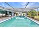 Large screened-in pool with patio furniture and bright natural light at 2236 Arnet St, Port Charlotte, FL 33948