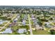 Wide aerial view of a residential community with various home styles and mature trees, near the horizon at 23104 Turnbull Ave, Port Charlotte, FL 33954
