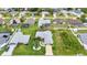 Aerial view of a home with a screened-in pool and beautiful landscaping in a residential community at 23104 Turnbull Ave, Port Charlotte, FL 33954
