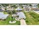 Overhead view of home showcases landscaping, screened-in pool, and overall neighborhood layout at 23104 Turnbull Ave, Port Charlotte, FL 33954
