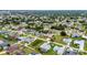 A neighborhood showcasing single-Gathering homes with well-maintained yards and a mix of mature trees at 23104 Turnbull Ave, Port Charlotte, FL 33954