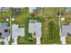 Aerial view of a home with a pool, well-manicured lawn, and a spacious driveway at 23104 Turnbull Ave, Port Charlotte, FL 33954