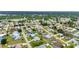 Expansive aerial view featuring a mix of homes with pools and lush greenery within a planned community at 23104 Turnbull Ave, Port Charlotte, FL 33954