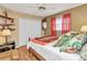 Comfortable bedroom featuring ample closet space and a view of the window at 23104 Turnbull Ave, Port Charlotte, FL 33954
