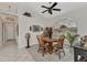 Bright dining area with a wooden table, chairs, and a decorative window at 23104 Turnbull Ave, Port Charlotte, FL 33954