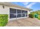 Two-car garage with screen doors, brick floor, and neatly organized storage inside at 23104 Turnbull Ave, Port Charlotte, FL 33954