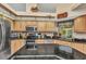Beautiful kitchen with stainless steel appliances, granite counters, and modern appliances and light wood cabinets at 23104 Turnbull Ave, Port Charlotte, FL 33954