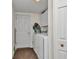 Bright laundry room with white appliances and storage, located near an exterior door at 23104 Turnbull Ave, Port Charlotte, FL 33954