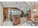 Bright living room with large windows, comfortable seating, and open floor plan at 23104 Turnbull Ave, Port Charlotte, FL 33954