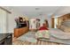 Comfortable primary bedroom with hardwood floors, ceiling fan and adjacent furniture at 23104 Turnbull Ave, Port Charlotte, FL 33954