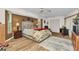 Large primary bedroom features hardwood floors, neutral colors, and an ensuite bath at 23104 Turnbull Ave, Port Charlotte, FL 33954