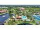 Stunning aerial view showcasing the community pool, shuffleboard, tennis court, spa and lush surroundings at 23465 Harborview Rd # 925, Punta Gorda, FL 33980