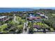 This aerial view highlights the community amenities, including lush landscaping, ponds with fountains and manicured grounds at 23465 Harborview Rd # 925, Punta Gorda, FL 33980