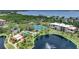 Beautiful aerial view of the community featuring a pond with fountain, pool, tennis and shuffleboard courts at 23465 Harborview Rd # 925, Punta Gorda, FL 33980