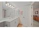 Bright bathroom featuring a vanity with cabinets, framed mirror, and a door leading to another room at 23465 Harborview Rd # 925, Punta Gorda, FL 33980