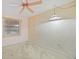 Inviting bedroom with a vintage ceiling fan and ambient lighting through a window at 23465 Harborview Rd # 925, Punta Gorda, FL 33980