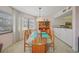 Bright dining room with glass table, wood chairs, and built-in cabinet for elegant condo living at 23465 Harborview Rd # 925, Punta Gorda, FL 33980