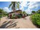Exterior community building with tropical plants at 23465 Harborview Rd # 925, Punta Gorda, FL 33980