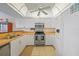 Well-lit kitchen with white appliances, wood countertops and tiled flooring for easy maintenance at 23465 Harborview Rd # 925, Punta Gorda, FL 33980