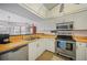Efficient kitchen layout with wood countertops, stainless steel appliances, and white cabinetry at 23465 Harborview Rd # 925, Punta Gorda, FL 33980
