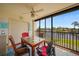 Enclosed lanai with comfortable seating offers serene views of the pond and fountains at 23465 Harborview Rd # 925, Punta Gorda, FL 33980