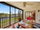 Enclosed lanai features a cozy table and chairs with peaceful views of the pond and fountains at 23465 Harborview Rd # 925, Punta Gorda, FL 33980