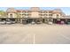 Exterior view of a multi-story building with covered parking spaces for residents and guests at 23465 Harborview Rd # 925, Punta Gorda, FL 33980