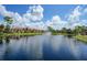 Scenic view of the pond with a fountain and community building at 23465 Harborview Rd # 925, Punta Gorda, FL 33980