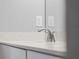 Close up of a bathroom counter with a modern faucet, quartz countertop, and neutral color scheme at 2354 Bonanza Ln, North Port, FL 34286