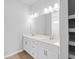 Bright bathroom features a double vanity with modern fixtures and a large mirror at 2354 Bonanza Ln, North Port, FL 34286