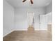 A spacious bedroom with light gray walls, ceiling fan, and wood-look tile at 2354 Bonanza Ln, North Port, FL 34286