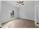 Bedroom with a window, ceiling fan, and wood-look tile at 2354 Bonanza Ln, North Port, FL 34286