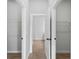 Hallway featuring an open door between two closet spaces at 2354 Bonanza Ln, North Port, FL 34286