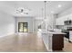 Kitchen with island open to living space, sliding glass doors lead to the backyard at 2354 Bonanza Ln, North Port, FL 34286