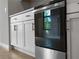 Stainless steel oven, white cabinets with modern gold pulls and quartz countertops make cooking a breeze at 2354 Bonanza Ln, North Port, FL 34286