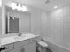 This renovated bathroom includes a shower-tub combo with white subway tiles and quartz vanity at 2372 Bonanza Ln, North Port, FL 34286