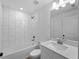 This updated bathroom has stylish subway tile, a shower-tub combo, and a modern vanity at 2372 Bonanza Ln, North Port, FL 34286