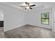This room features wood-look tile flooring, a modern ceiling fan, and a sunny window at 2372 Bonanza Ln, North Port, FL 34286