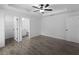 This bedroom features tile flooring, a ceiling fan, an en-suite bathroom, and a walk-in closet at 2372 Bonanza Ln, North Port, FL 34286